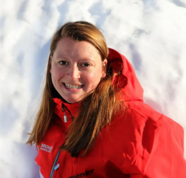 Person in red parka against a snowy backdrop