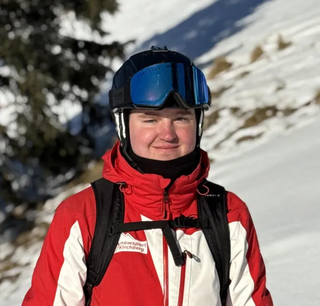 Skier Lennard in red and white jacket on snow