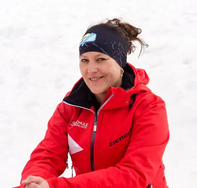 Woman in red jacket with snowy background