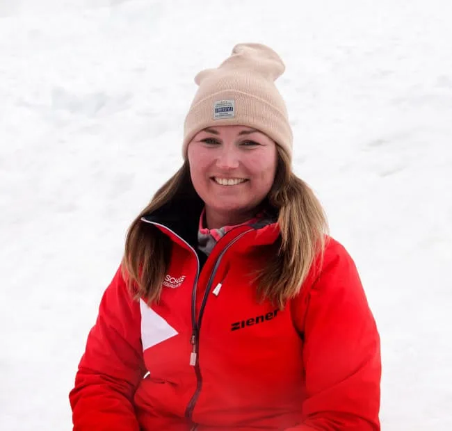 Woman in red jacket against snowy background