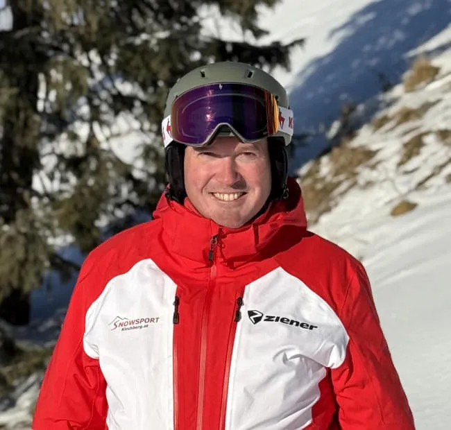 Man in helmet and red jacket on snow