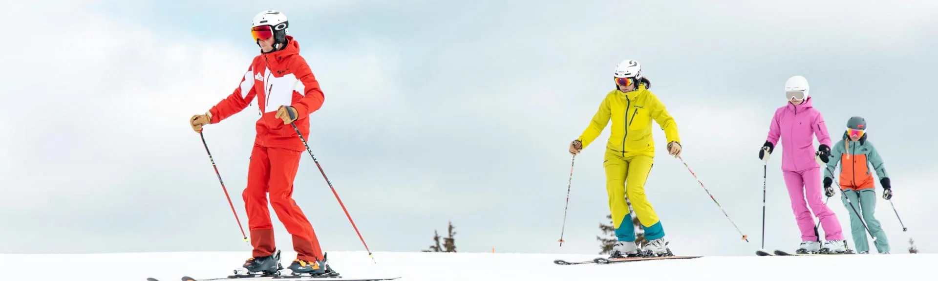 Skiers in colorful outfits on the slopes in Kirchberg